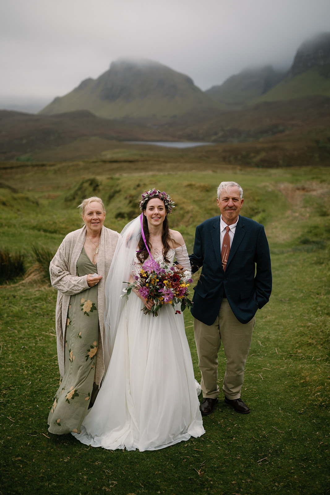 Becca and her parents, accompanied by the melodic notes of a bagpipe, walk toward the ceremony spot at the Isle of Skye