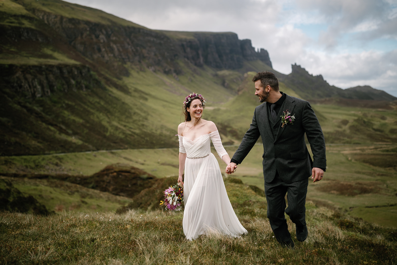 Nick and Becca, hand in hand, traverse the mystical landscape of Quiraing, capturing the essence of their elopement day