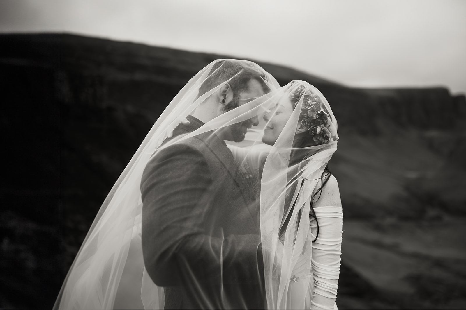 Nick and Becca, amidst the captivating Quiraing, share a moment of connection and love during their elopement photoshoot