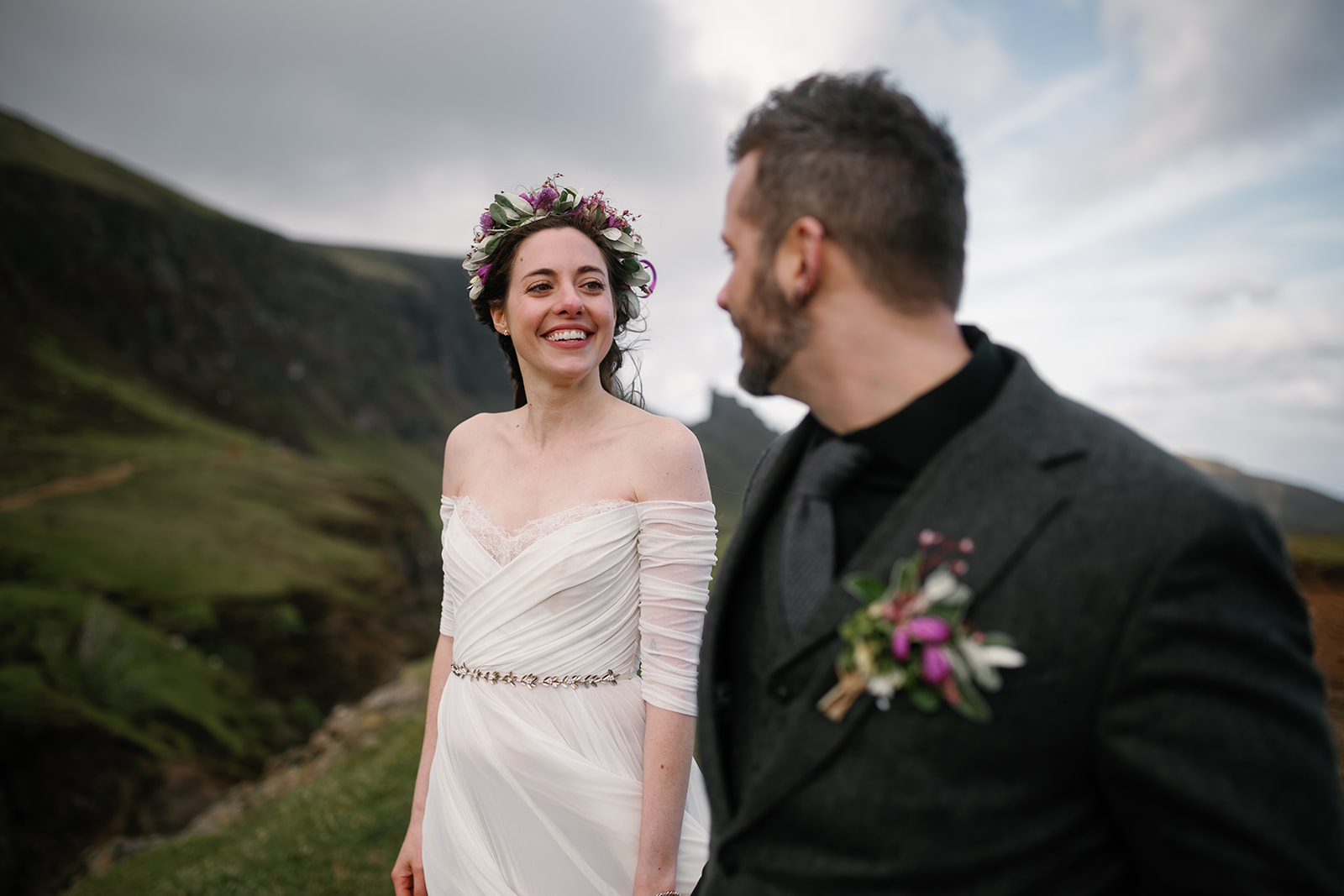 Becca and Nick, framed by the beautiful Quiraing, share a moment of pure joy during their elopement day