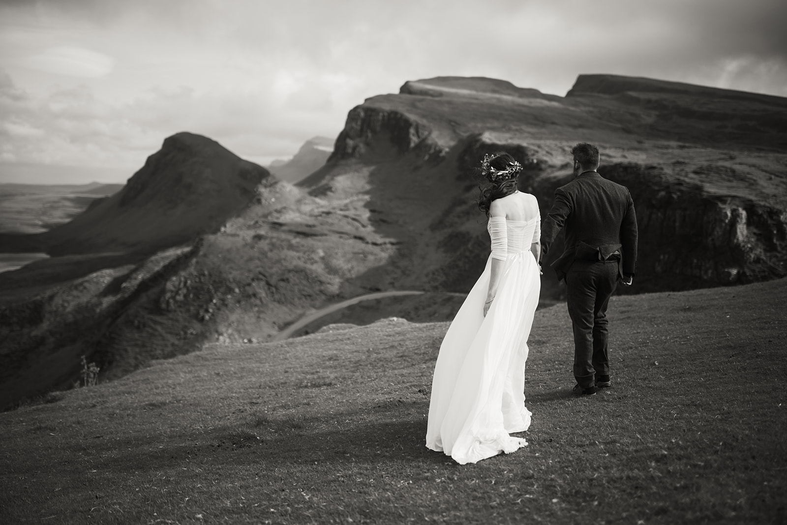 Nick and Becca, hand in hand, traverse the mystical landscape of Quiraing, capturing the essence of their elopement day