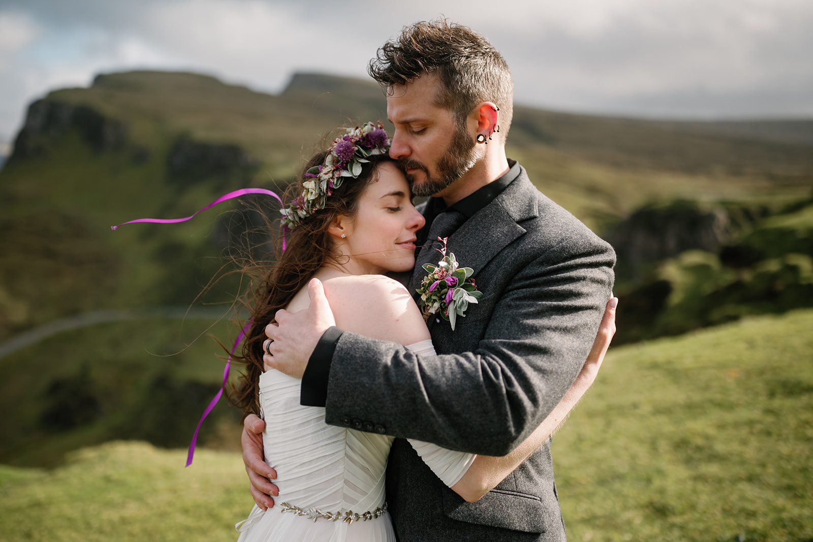Becca and Nick, surrounded by the ancient beauty of Quiraing, find solace in each others arms during their elopement day