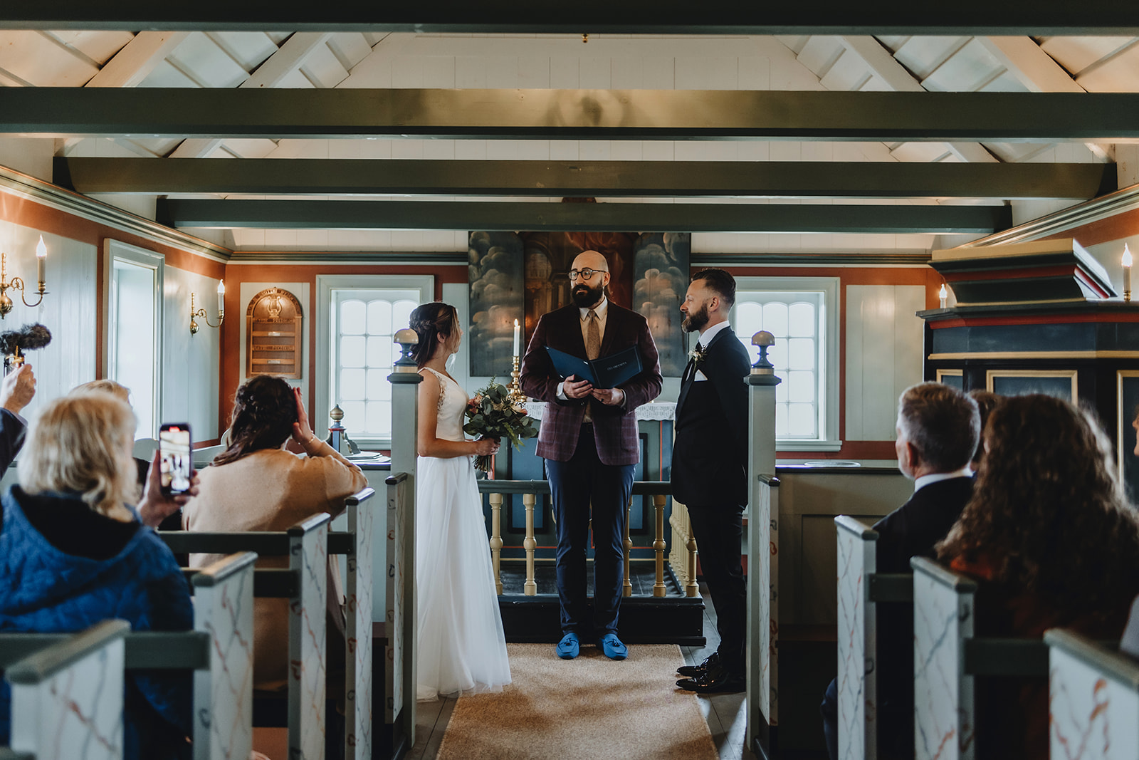 couple is getting married in the black church in Iceland