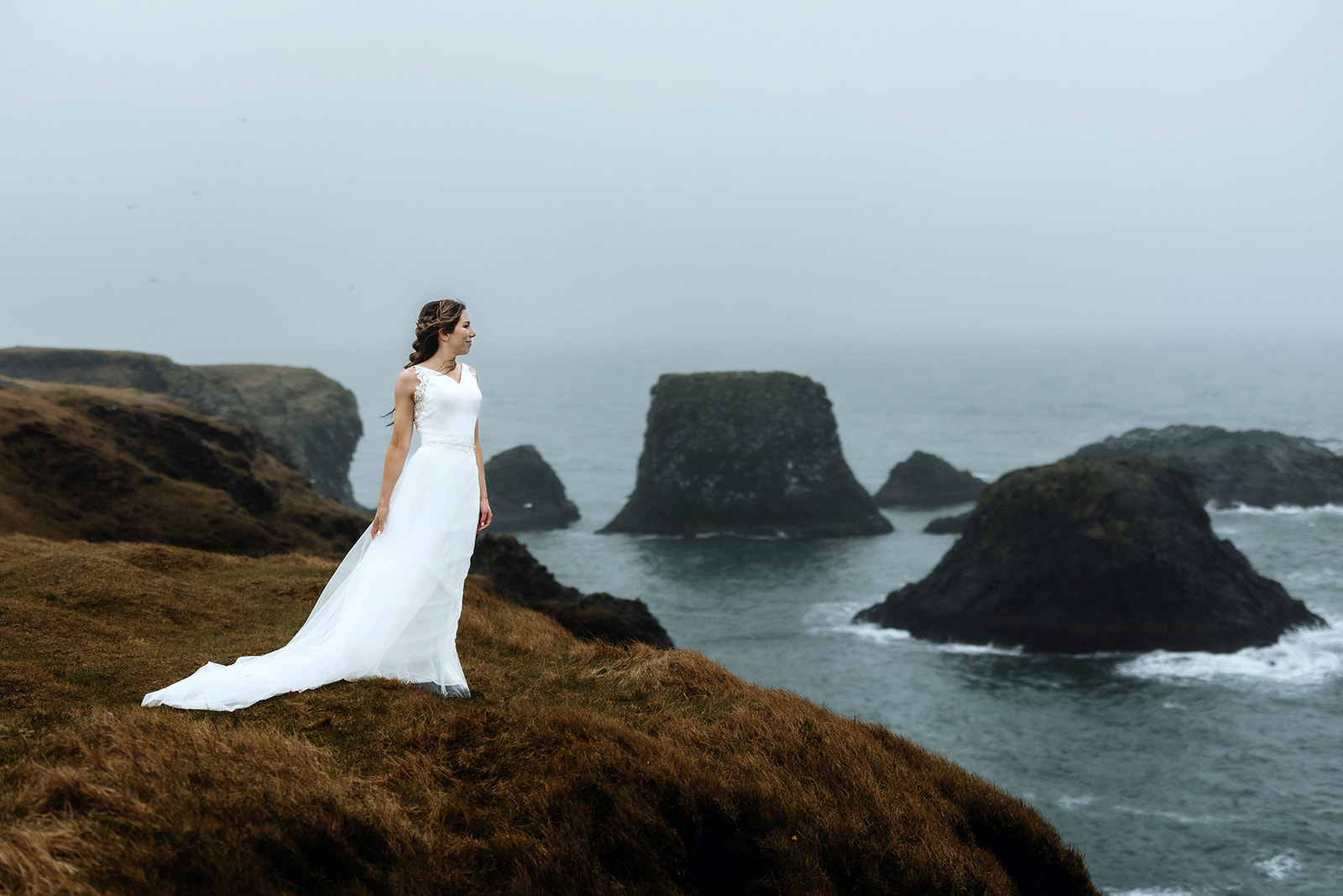 Bride who got married in Iceland standing in front of the ocean
