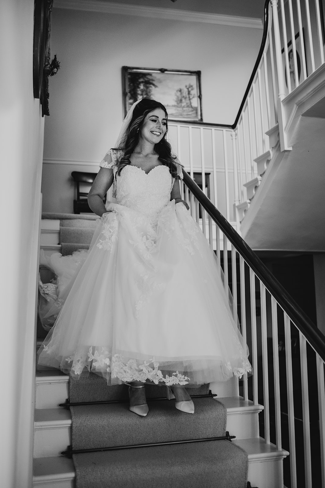 bride walks down stairs in wedding dress