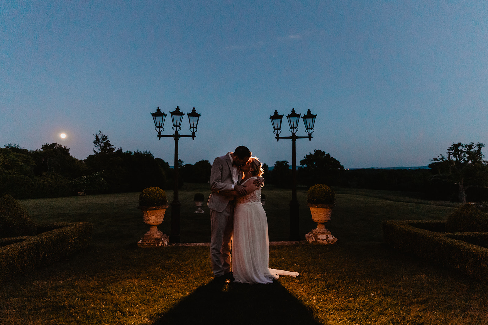 Bride and groom outside at dusk at a South Lodge, Sussex Wedding. By Olive Joy Photography