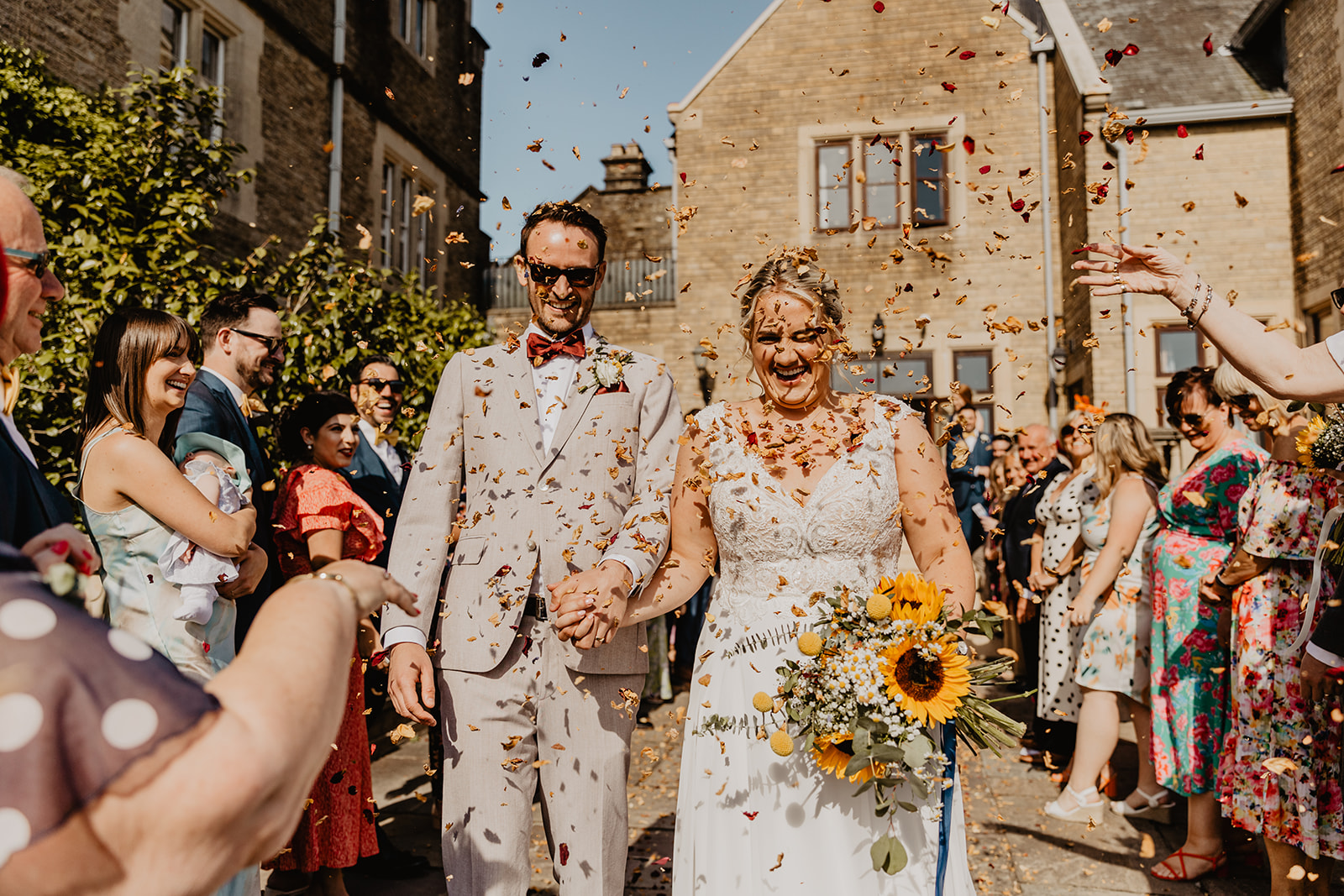 Bride and Groom under confetti at a South Lodge, Sussex Wedding. By Olive Joy Photography