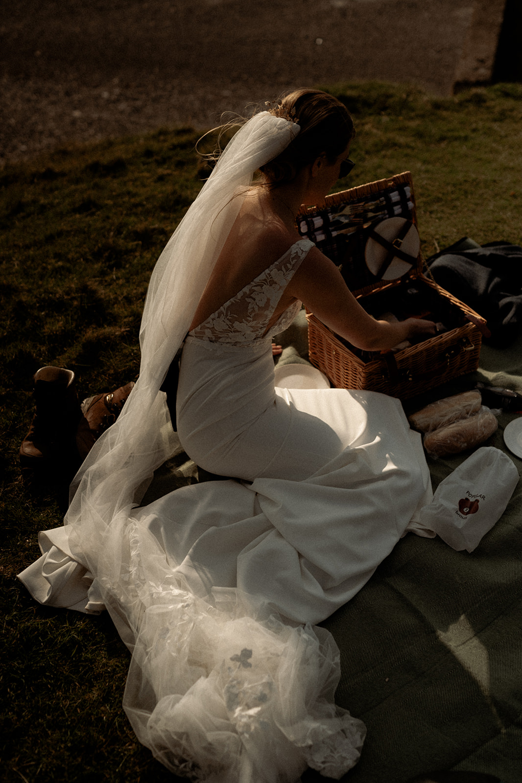 a bride enjoying a picnic after their elopement wedding at Penarth Fawr