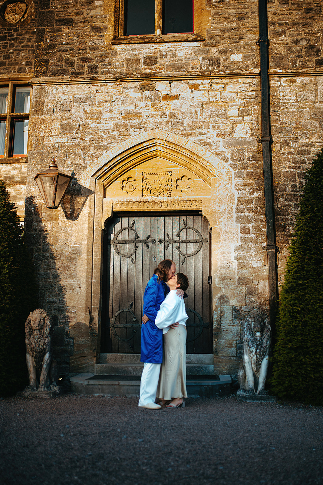 Gentle embrace: Couple in love sharing a passionate kiss in front of the enchanting Huntsham Court castle, England