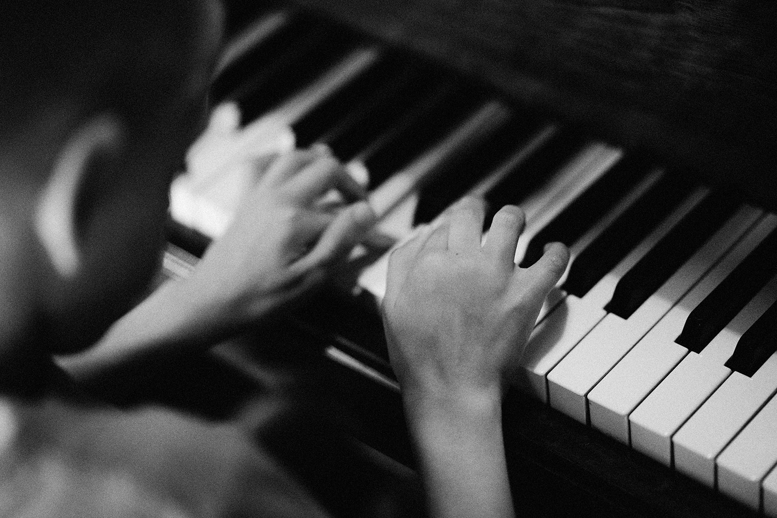 Child hand play piano in Huntsham Court castle, England
