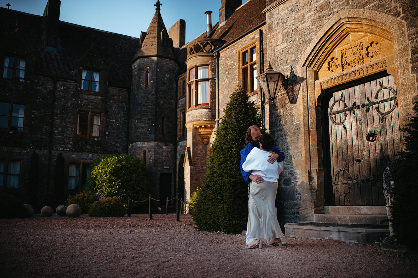 A kiss to remember: Embracing romance, the couple kisses in front of the stunning Huntsham Court castle, England