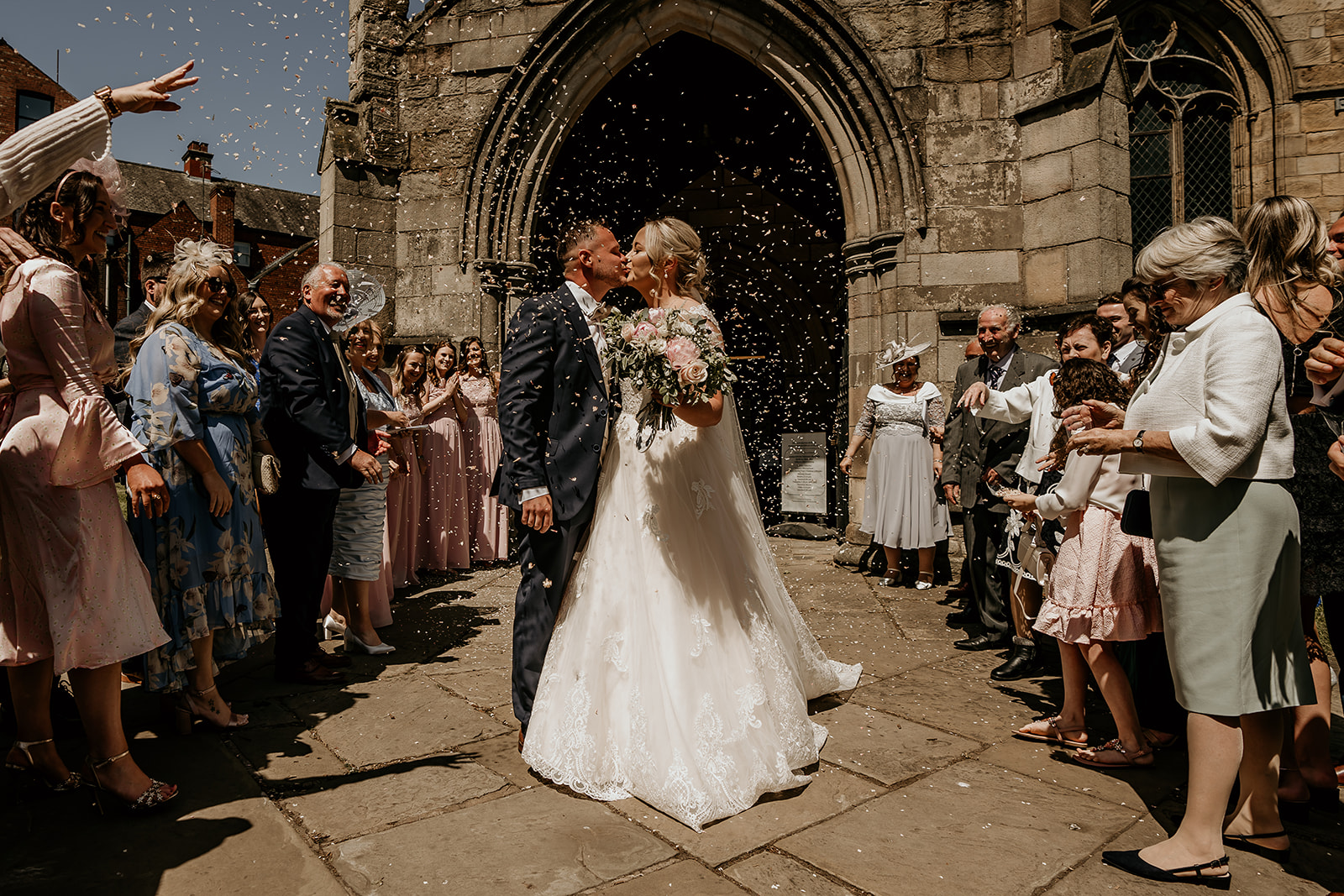 kiss and confetti at wedding 