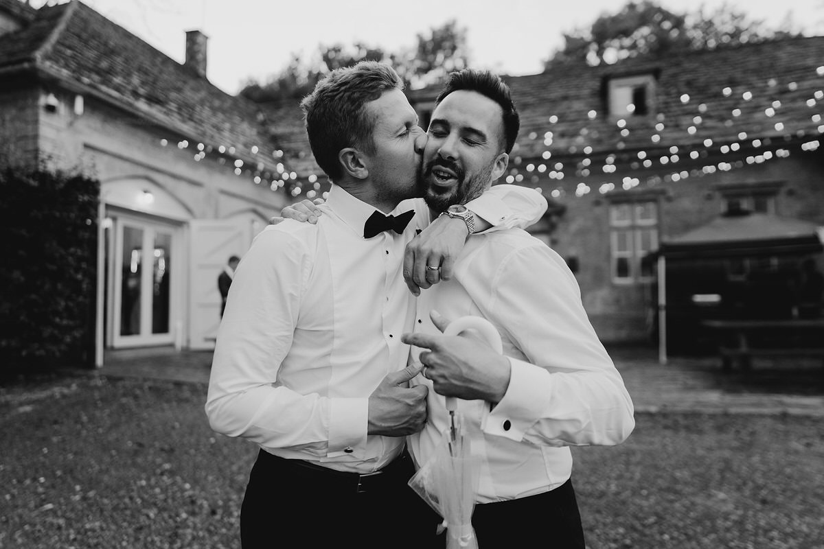 best man kissing groomsmen