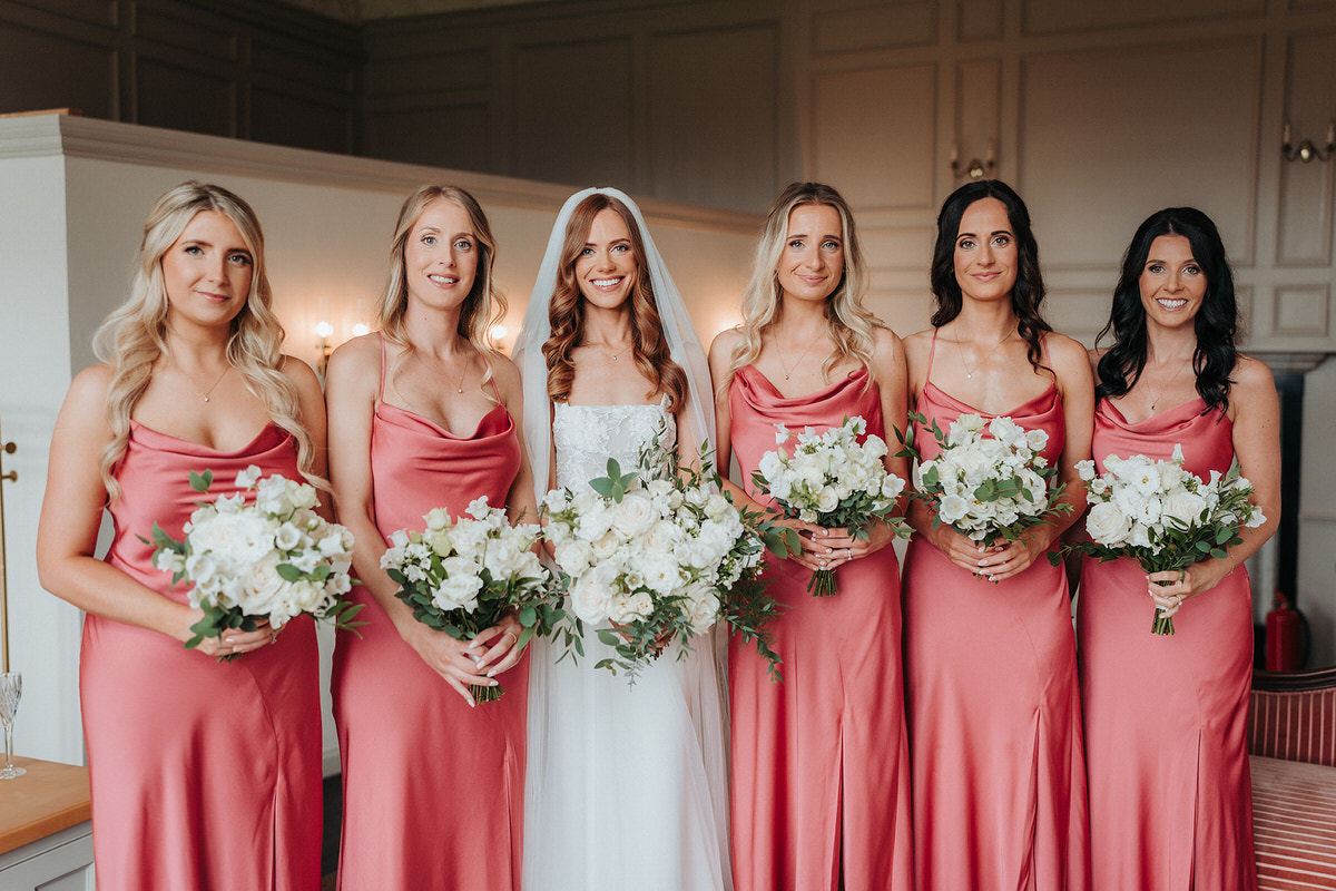 bride and bridesmaids posing for wedding photographer at Brympton House 