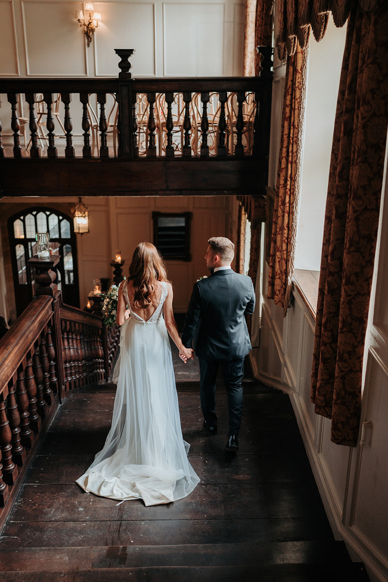 bride and groom walking down the staircase at Brympton House 