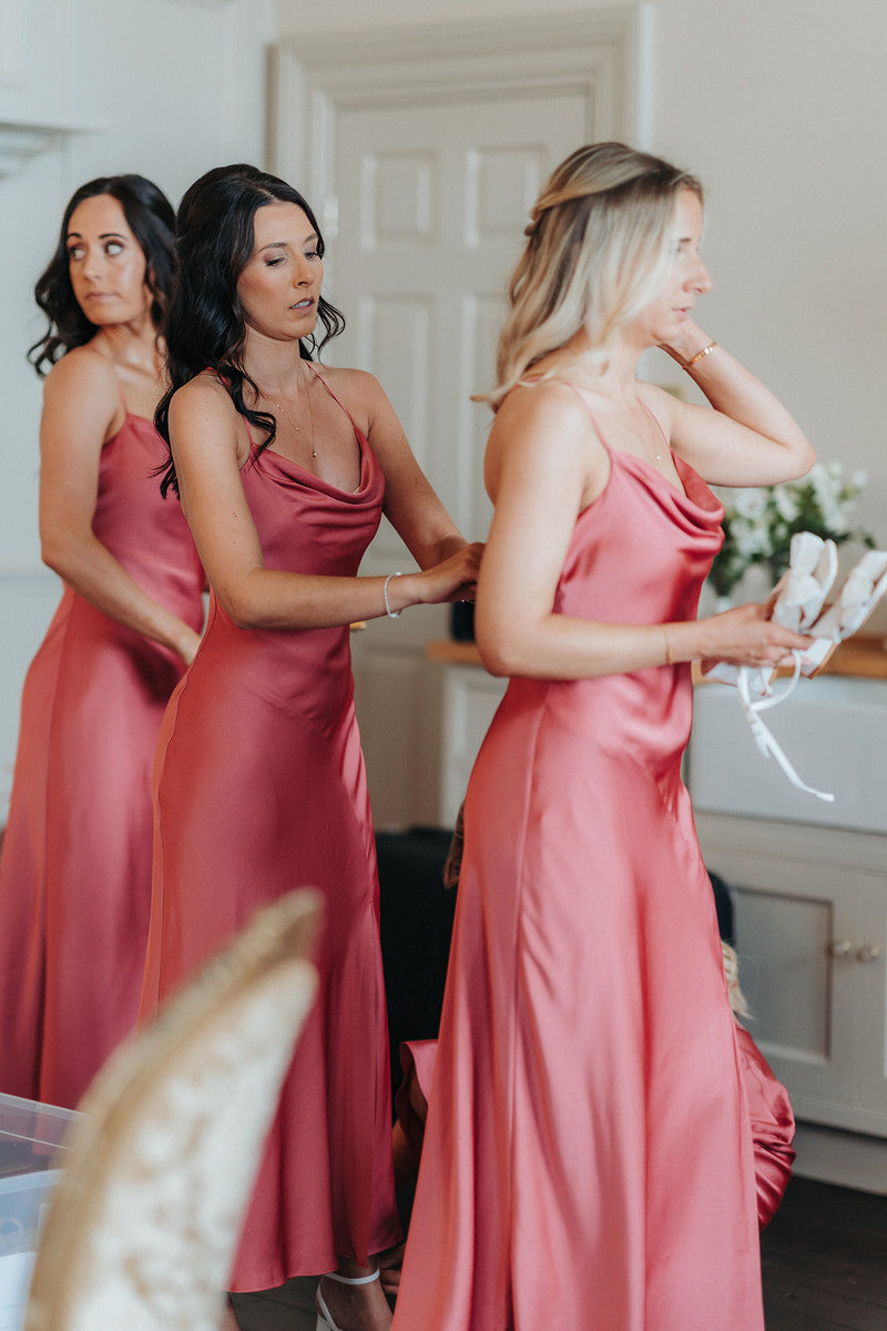 bridesmaids helping each other get ready at Brympton House 
