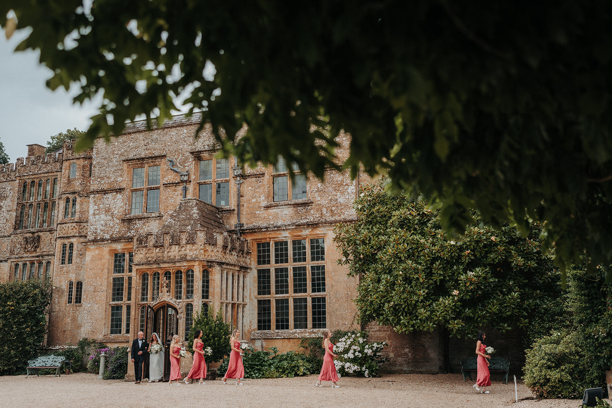bridesmaids walking to the ceremony at Brympton House 