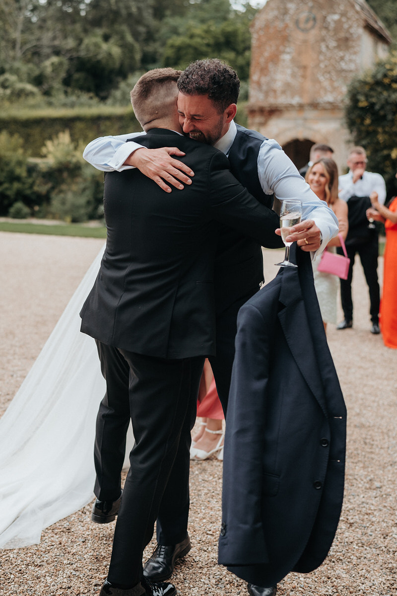 groom hugs the wedding guest 