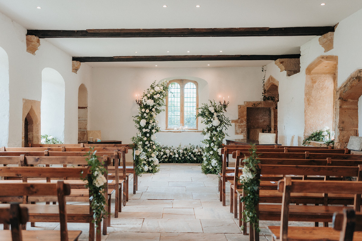 the castle house ceremony room at Brympton House with flower arch