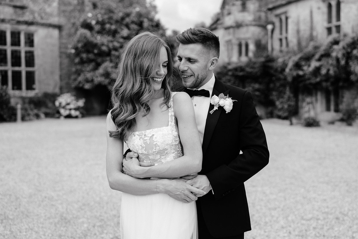 wedding couple embracing for the photographer at Brympton 