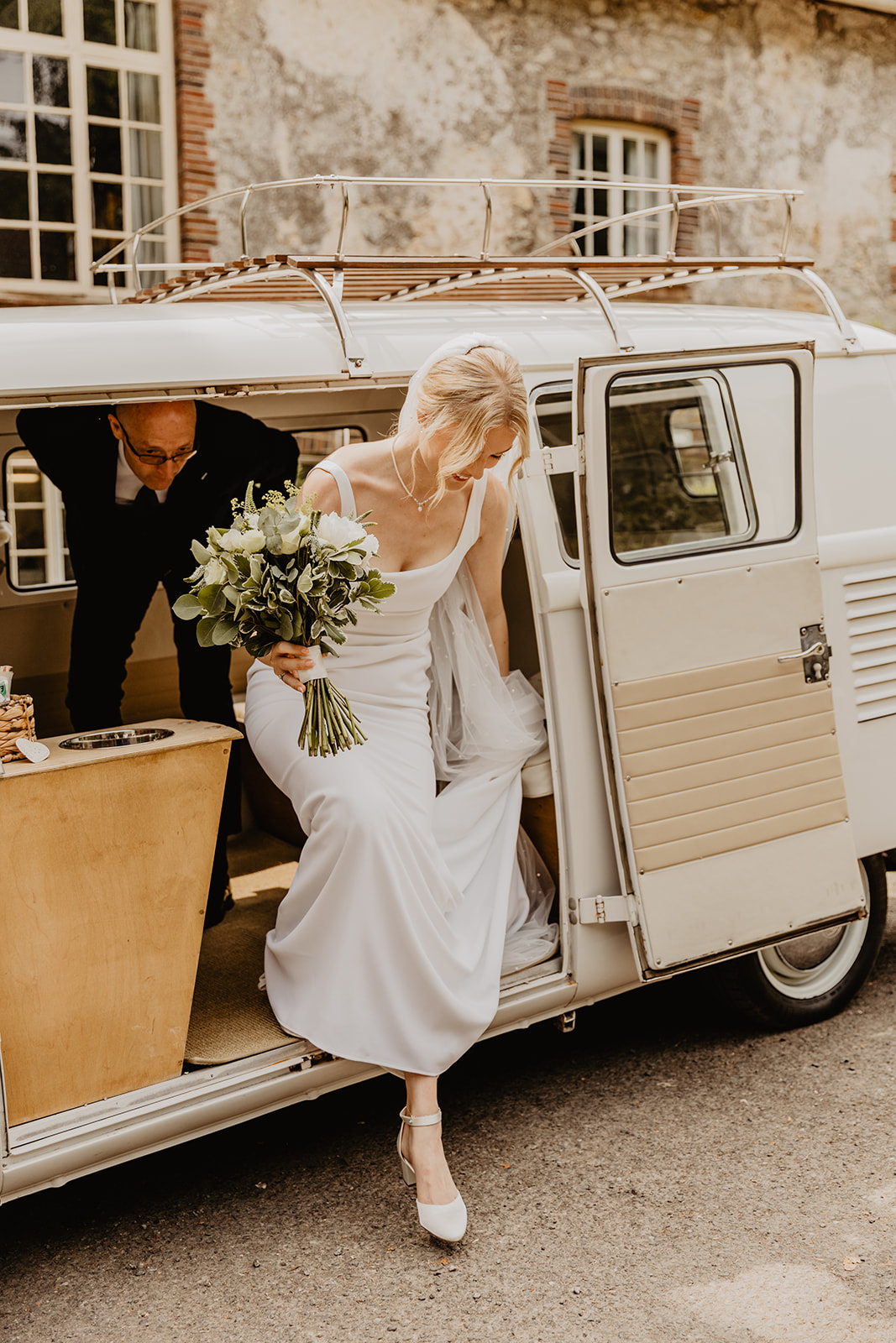 Bride arriving in her VW camper at a Bury Manor Barn Wedding in Sussex. Photographer OliveJoy Photography.