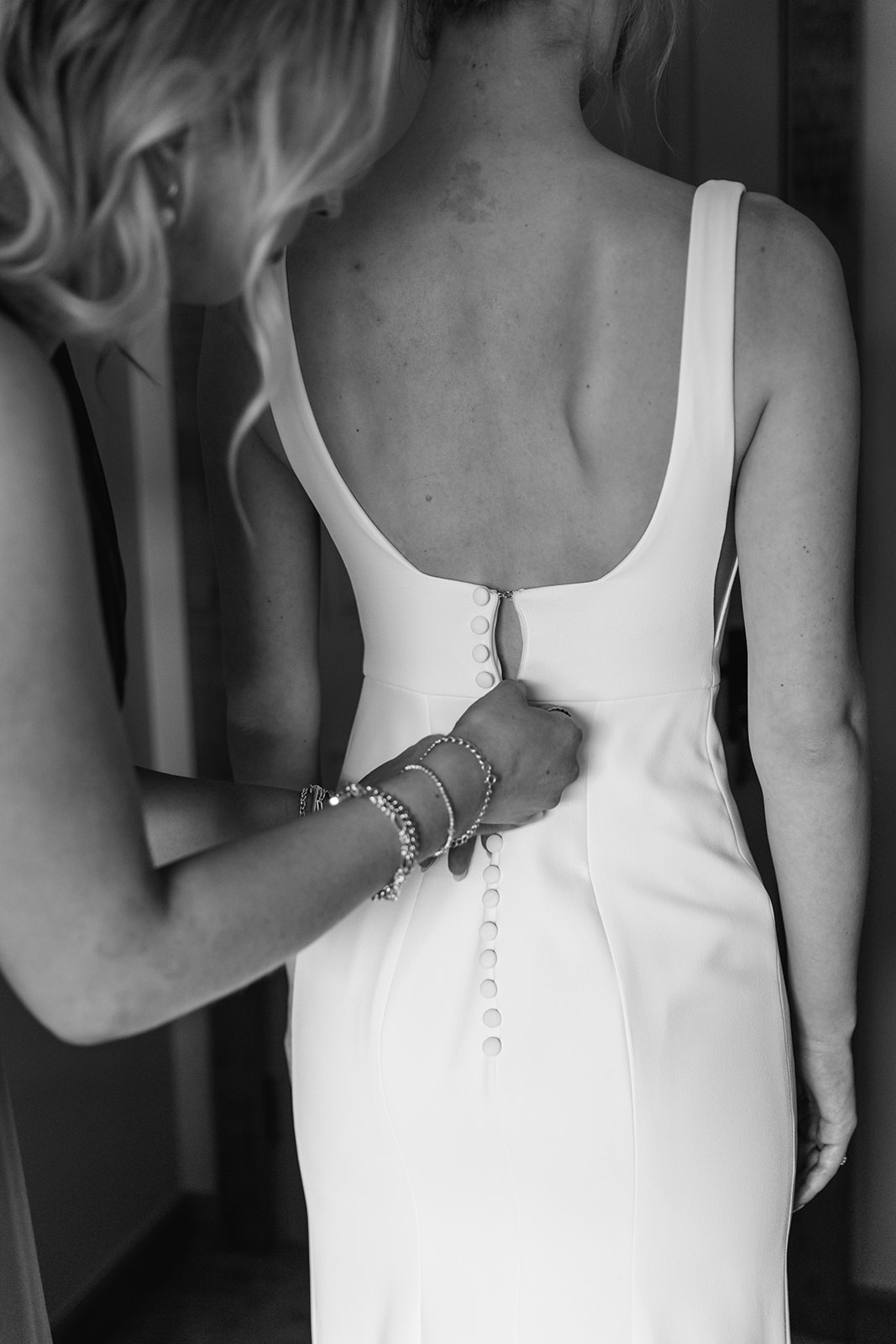 Bride getting in dress at a Bury Manor Barn Wedding in Sussex. Photographer OliveJoy Photography.
