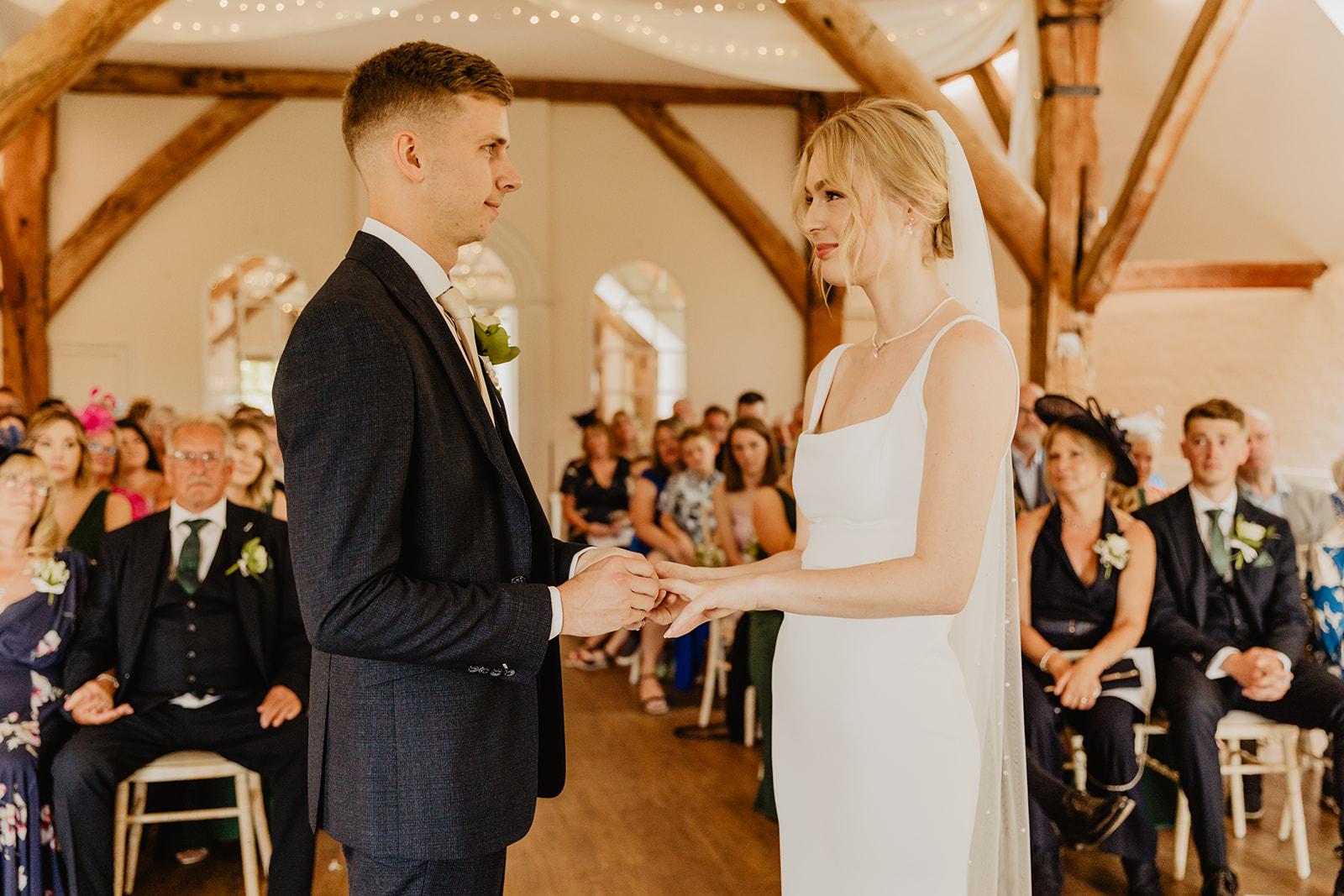 Bride and groom during ceremony at a Bury Manor Barn Wedding in Sussex. Photographer OliveJoy Photography.