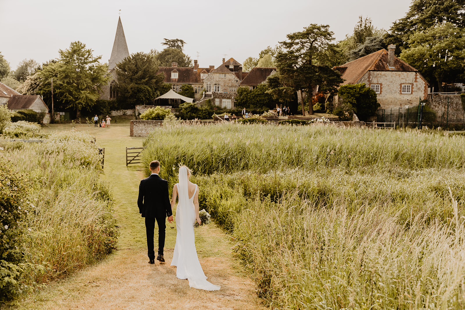 Bride and Groom golden hour photos at a Bury Manor Barn Wedding in Sussex. Photographer OliveJoy Photography.