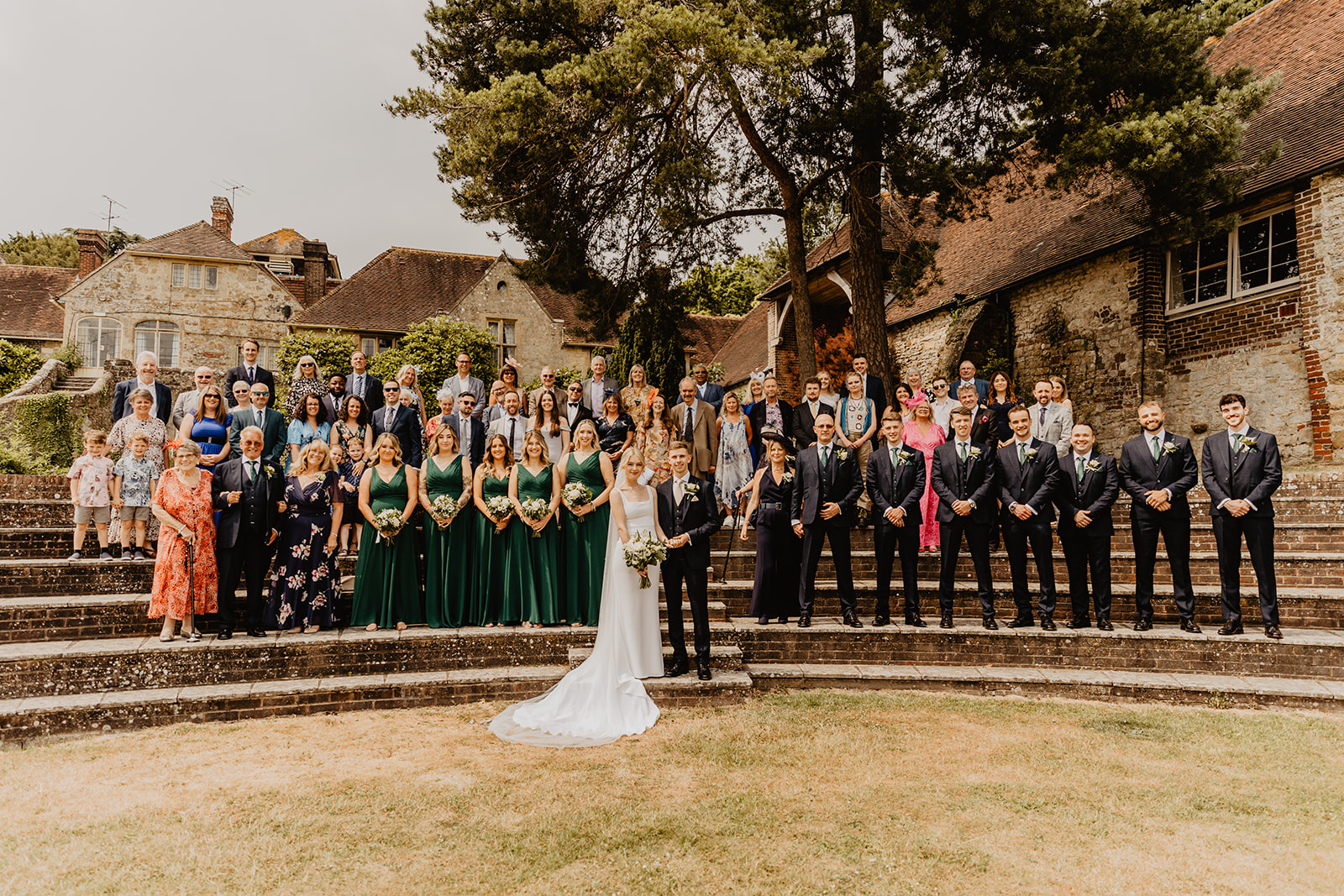 Wedding guests group photo at a Bury Manor Barn Wedding in Sussex. Photographer OliveJoy Photography.