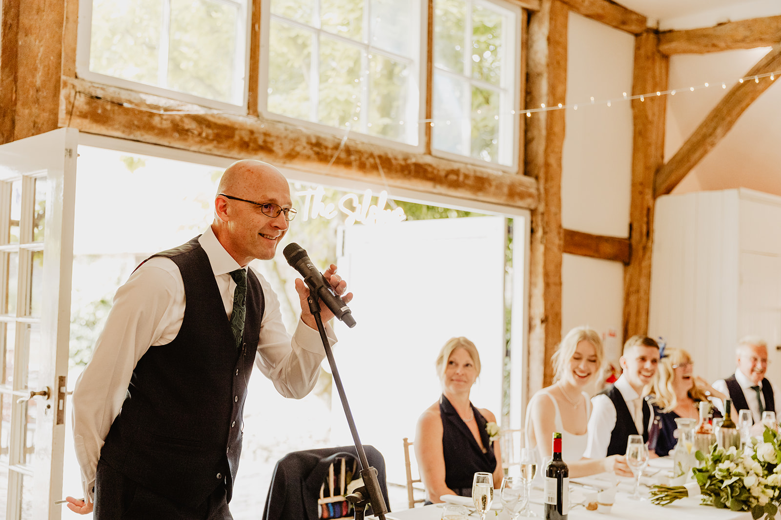Wedding speeches at a Bury Manor Barn Wedding in Sussex. Photographer OliveJoy Photography.