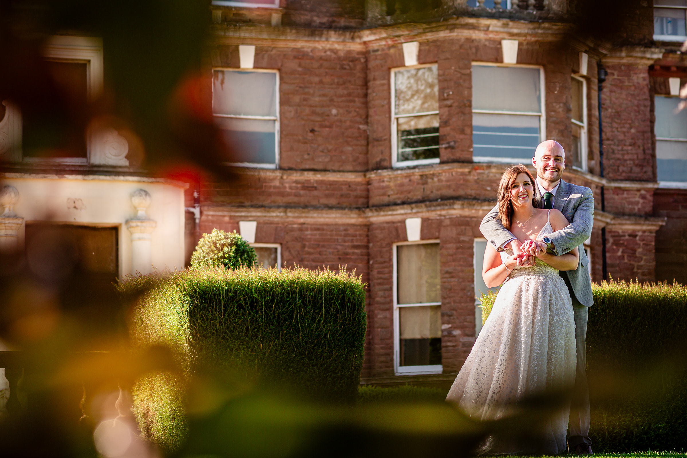 newly married couple embrace outside Bredenbury Court Barns