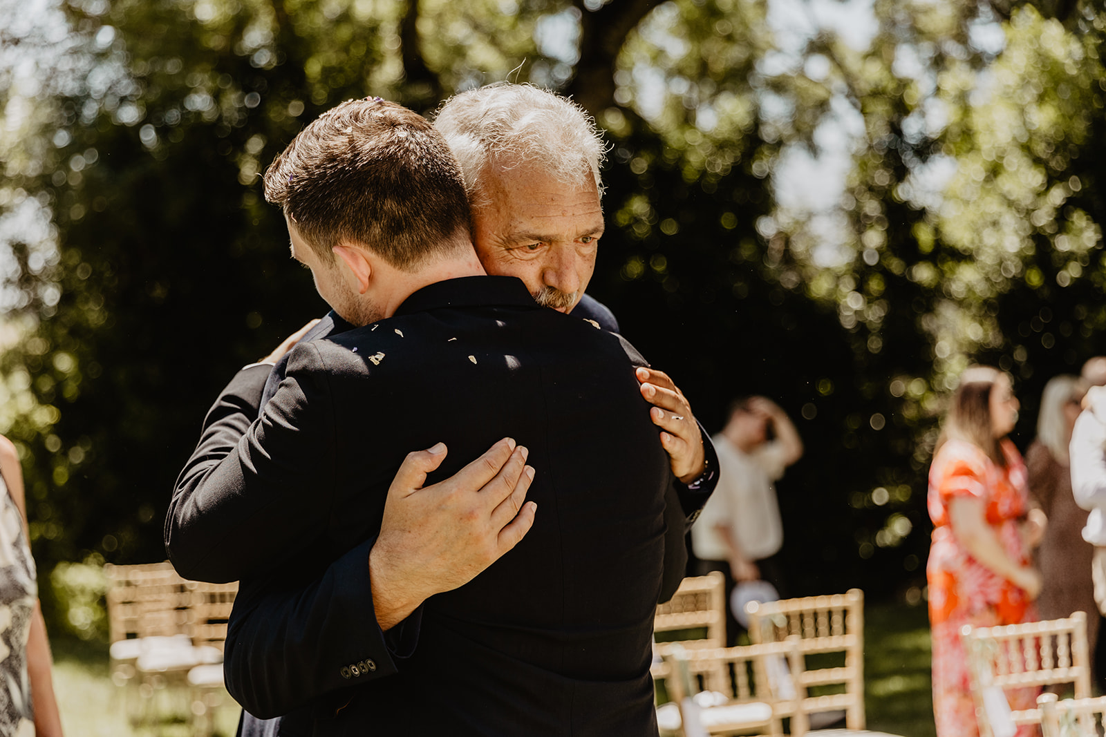 Groom hugging his dad at a France Destination Wedding. Photography and Videography by Olive Joy Photography