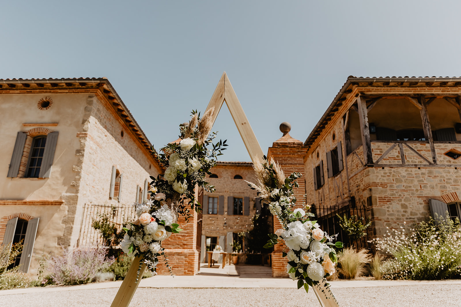 Floral arch at a Destination Wedding in France. Photography & Videography by OliveJoy Photography