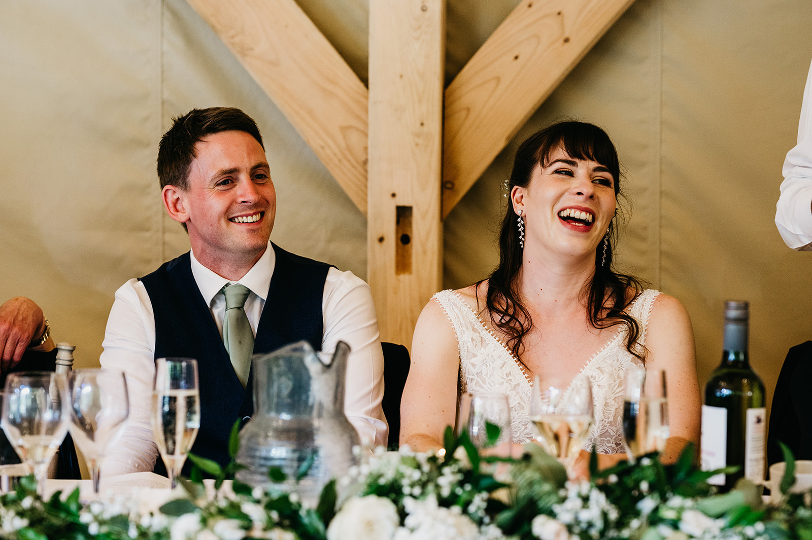 bride and groom laugh during speeches in malvern 