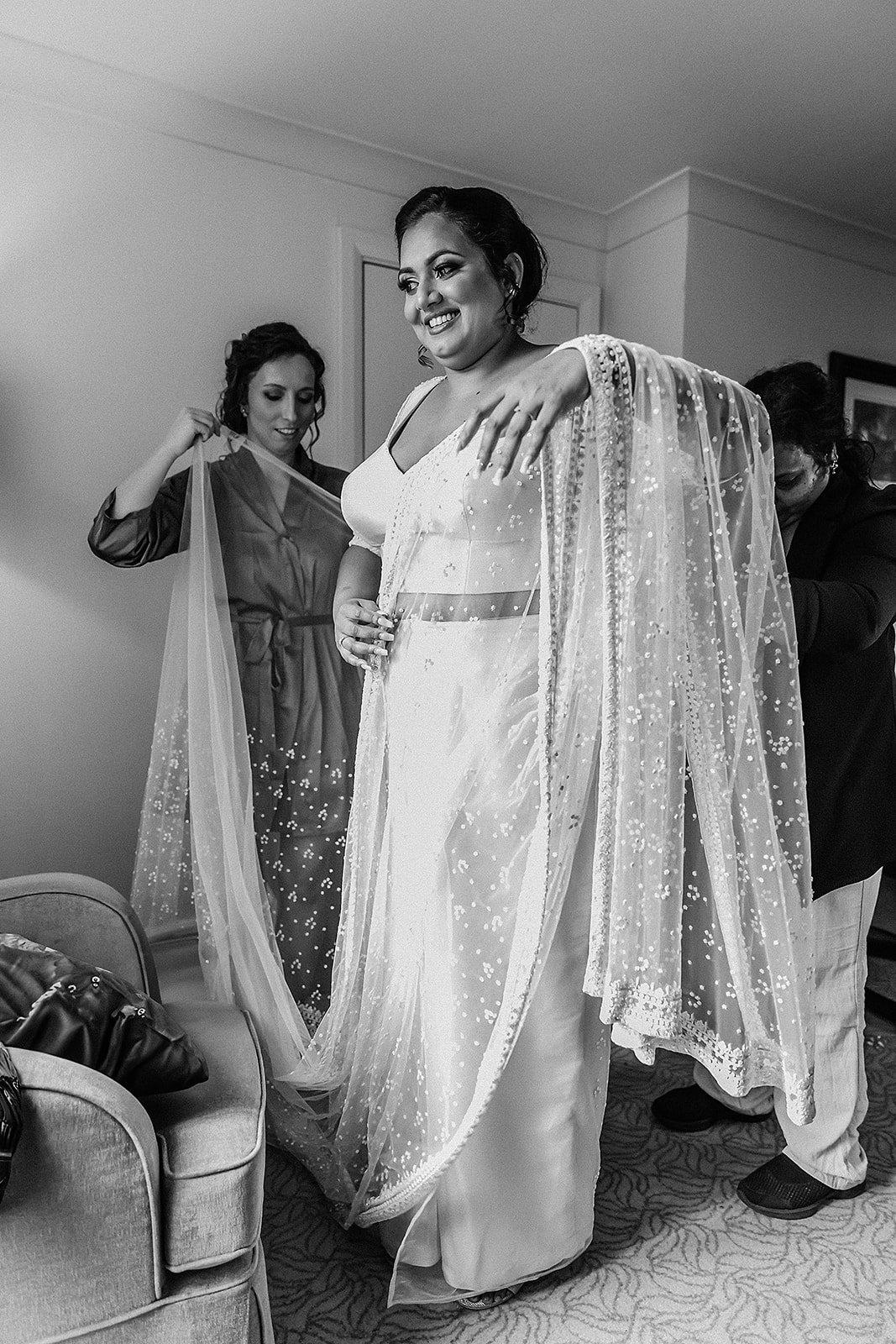 bride putting on her bridal saree