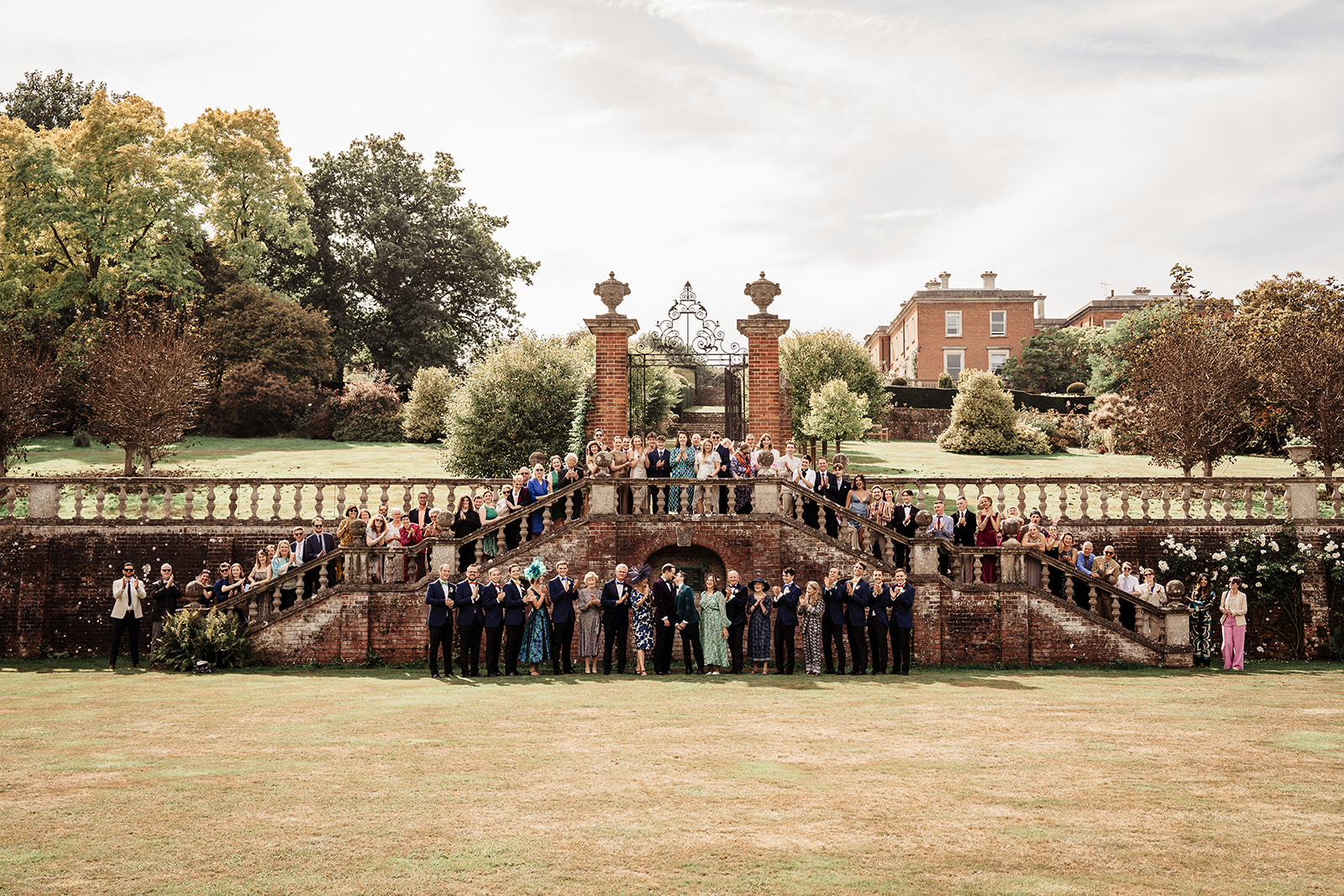 Large wedding party photo on steps at Mount Ephraim Country House & Gardens