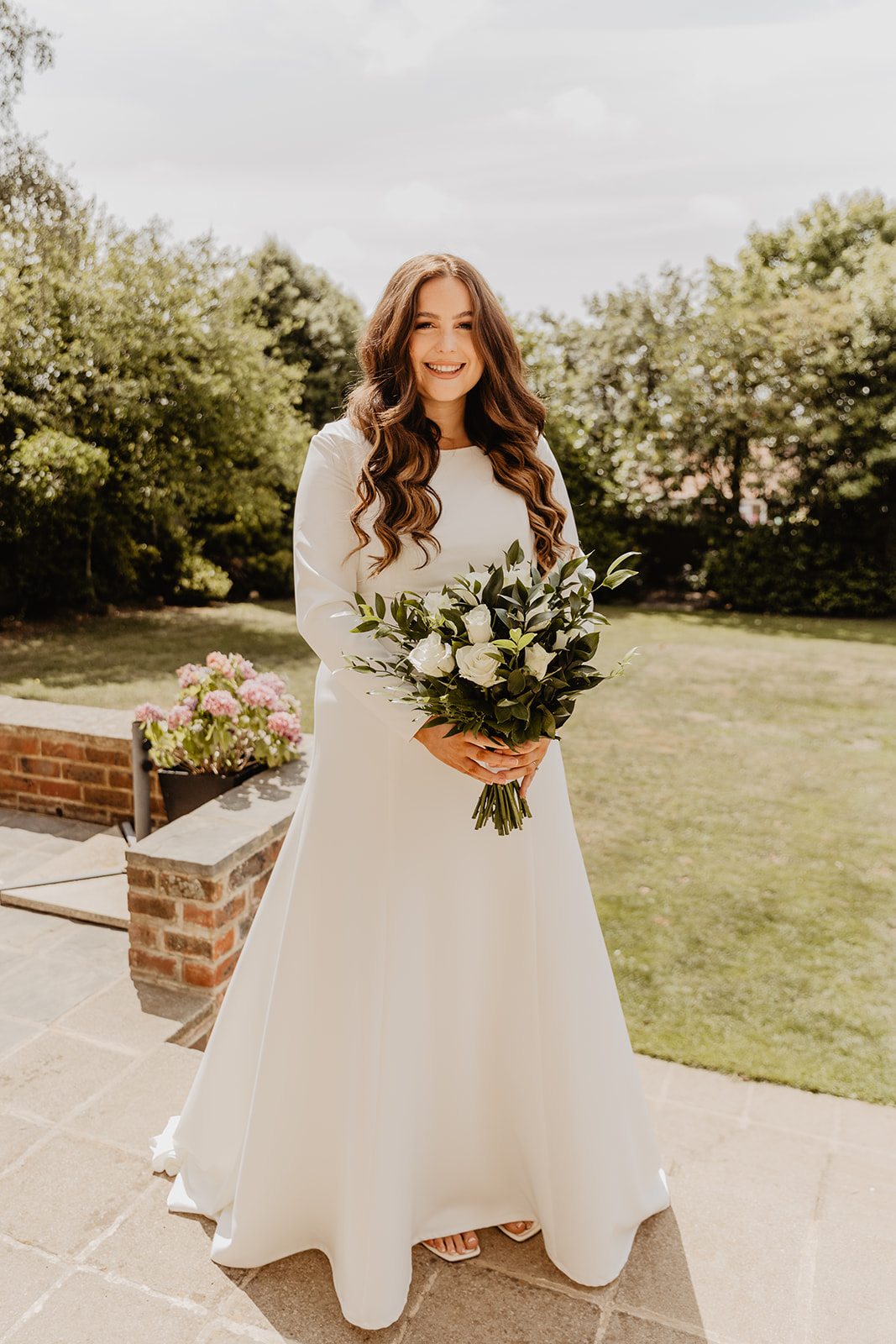 Bride with bouquet at a Field Place Manor House Wedding in Worthing, Sussex. By Olive Joy Photography