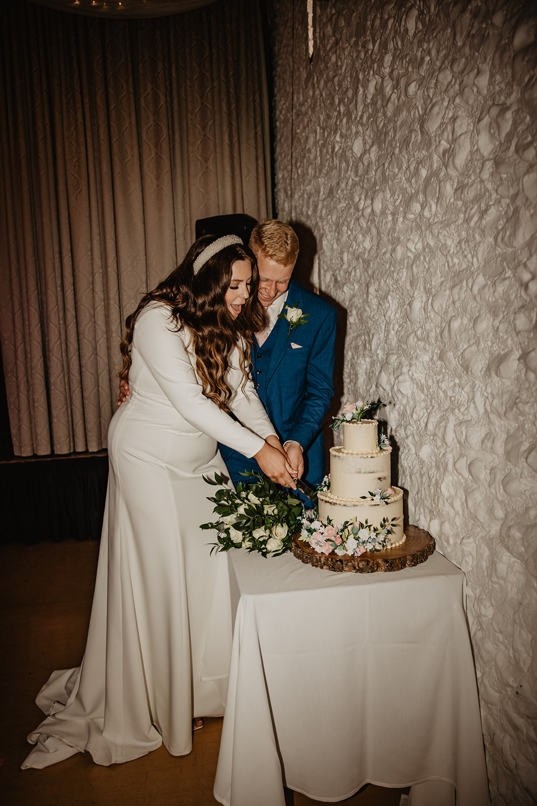 Bride and Groom cutting cake at a Field Place Manor House Wedding in Worthing, Sussex. By Olive Joy Photography