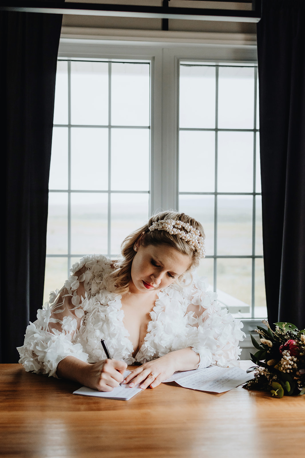 Bride is finishing writing her wedding vows in the morning of her wedding in Iceland