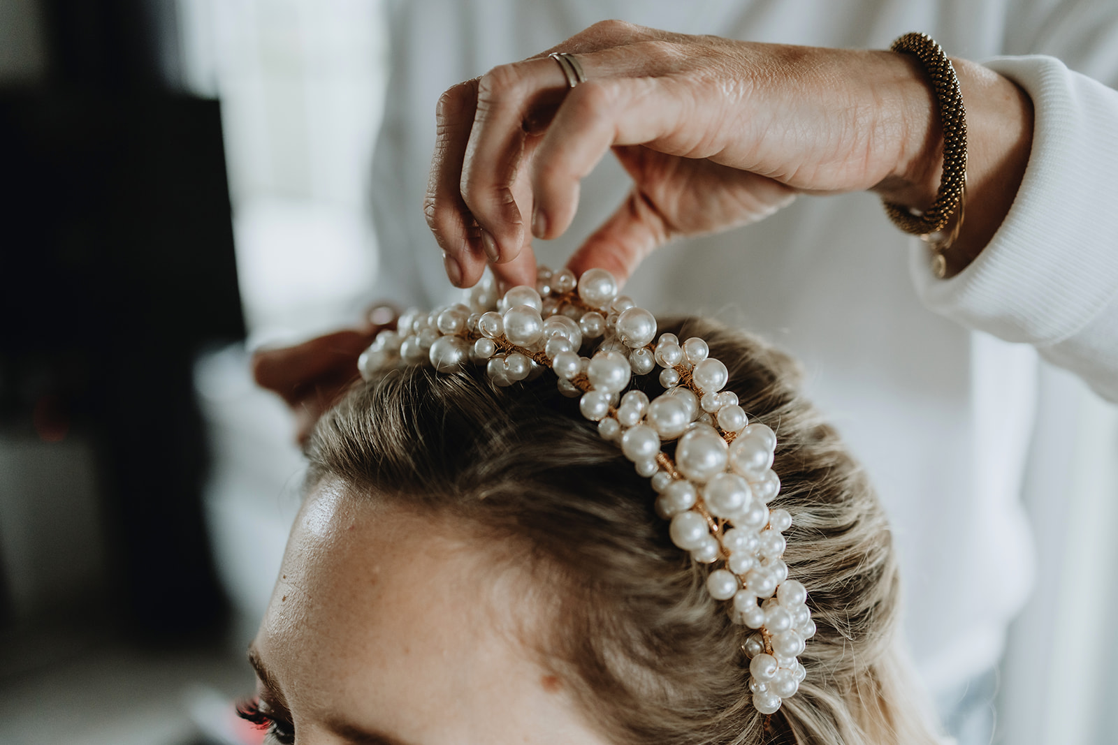 Detail shots of a wedding in Iceland. Bride is putting on her tiara
