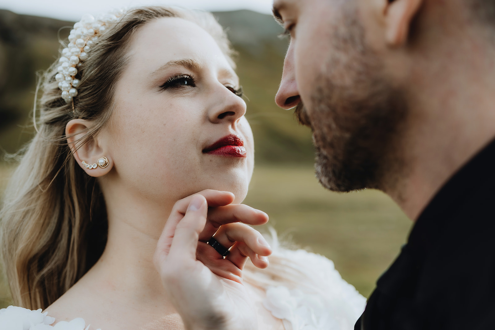 Close-up of the groom holding his wife's chin on their adventure elopement in the Icelandic highlands. 