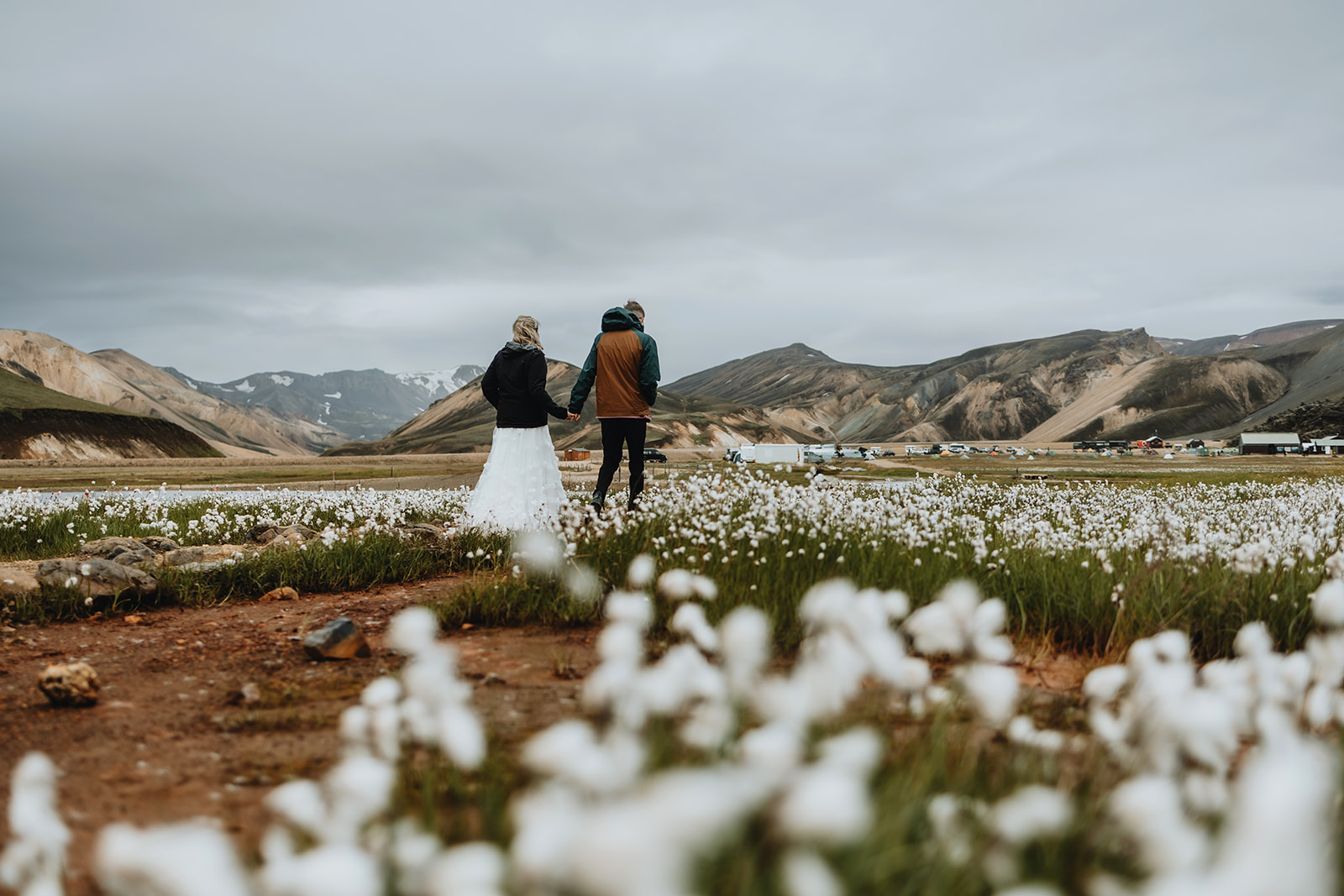 Newlywed couple is walking towards Landmannalaugar on their wedding day in Iceland
