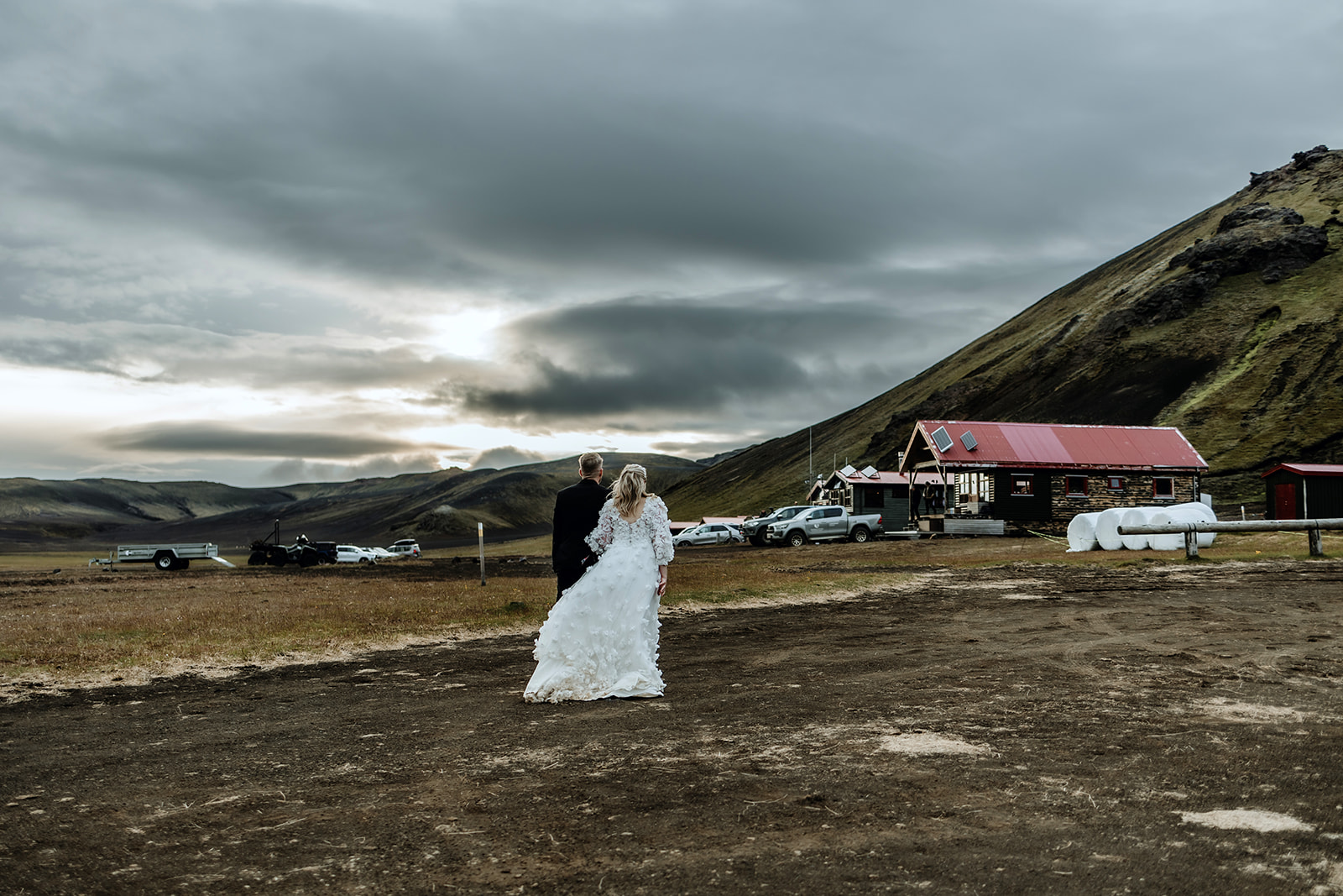 Bride and Groom are taking a walk in the sunset in the highlands in Iceland.