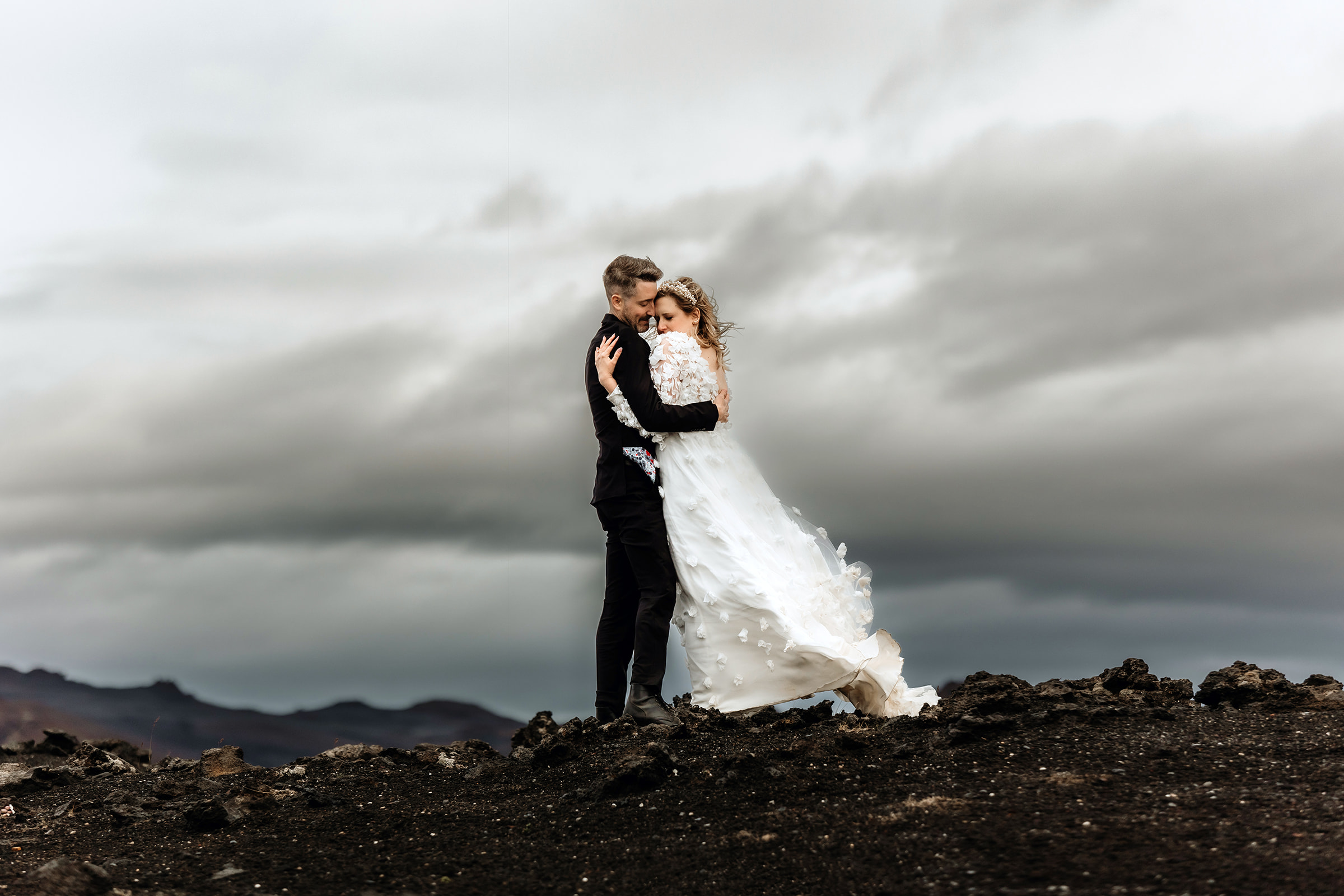 Canadian married couple is hugging in the Icelandic highlands. Iceland summer elopement and wedding photographer