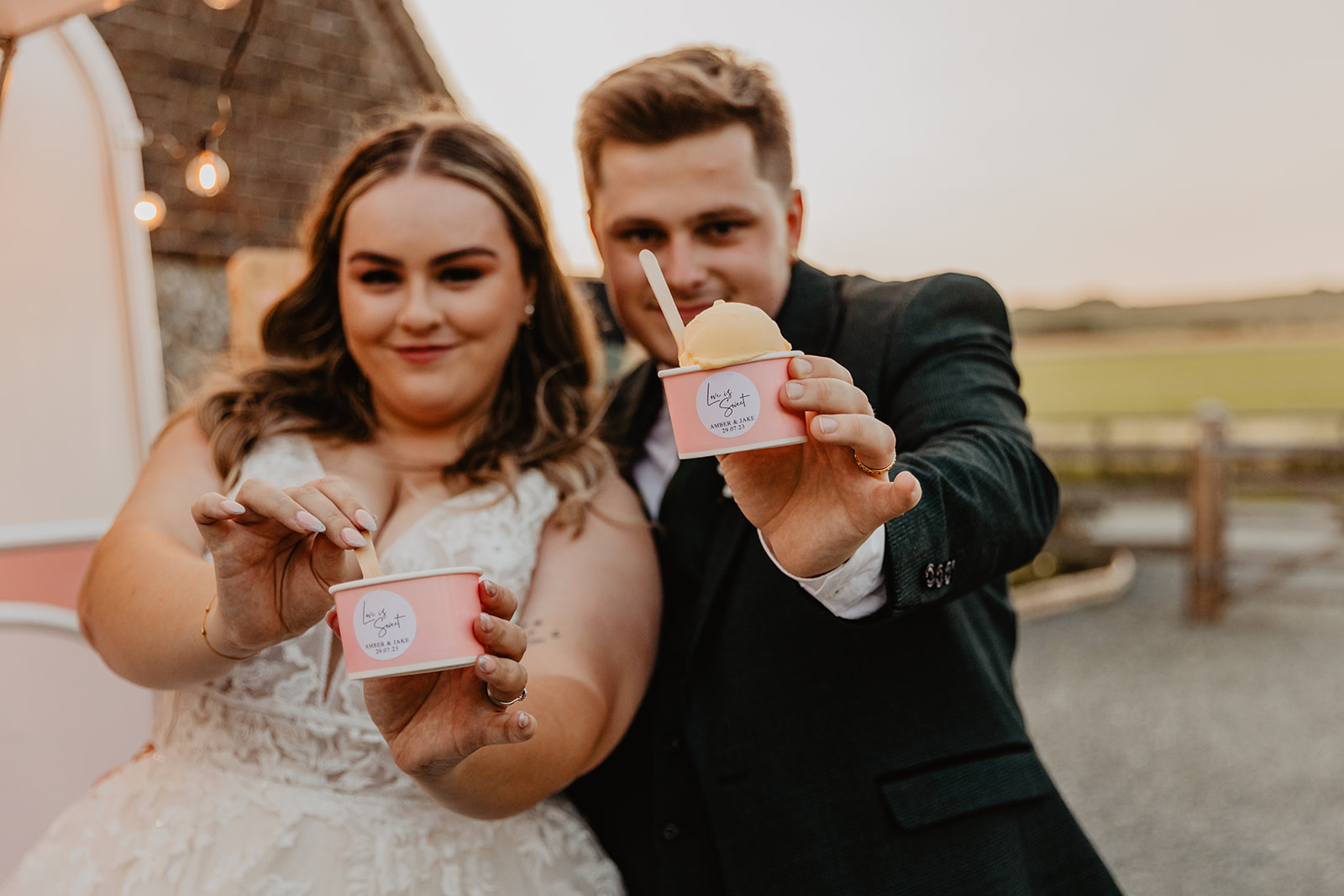 Bride and Groom eat ice cream at a Long Furlong Barn Wedding in Worthing, Sussex. By Olive Joy Photography.