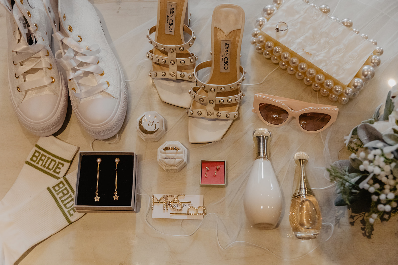Flat lay of bride items at a Long Furlong Barn Wedding in Worthing, Sussex. By Olive Joy Photography.