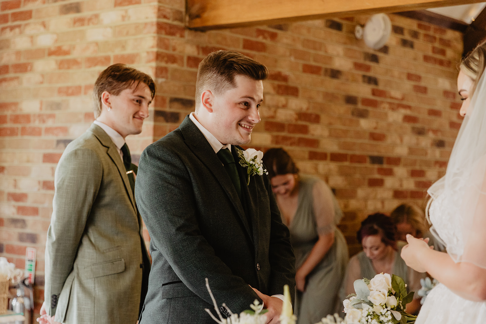 Groom meets bride at a Long Furlong Barn Wedding in Worthing, Sussex. By Olive Joy Photography.