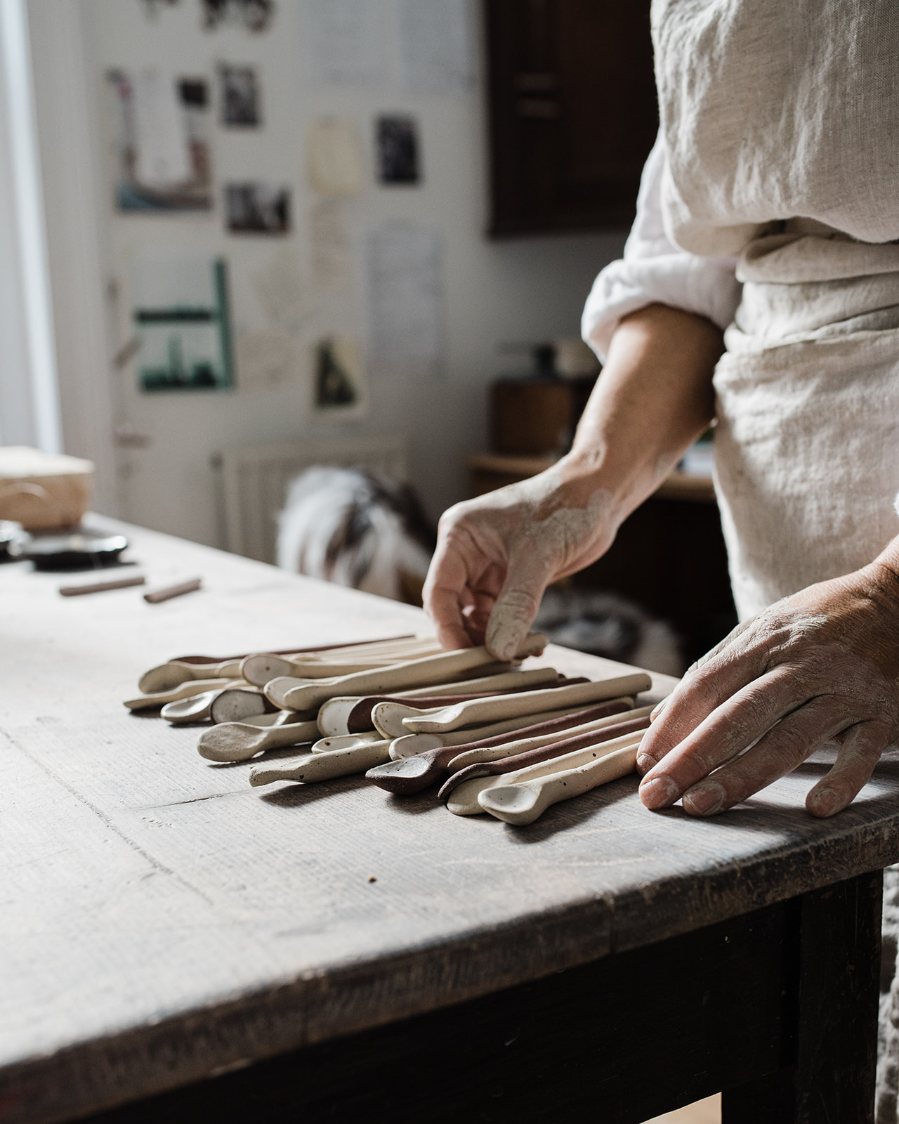 Handmade ceramic spoons on a wooden table.