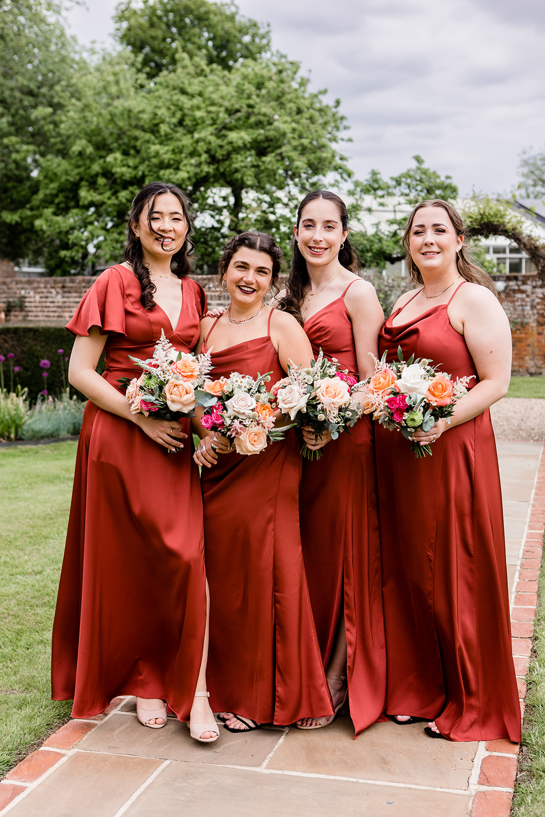 bridesmaids wearing their gorgeous burnt orange dresses
