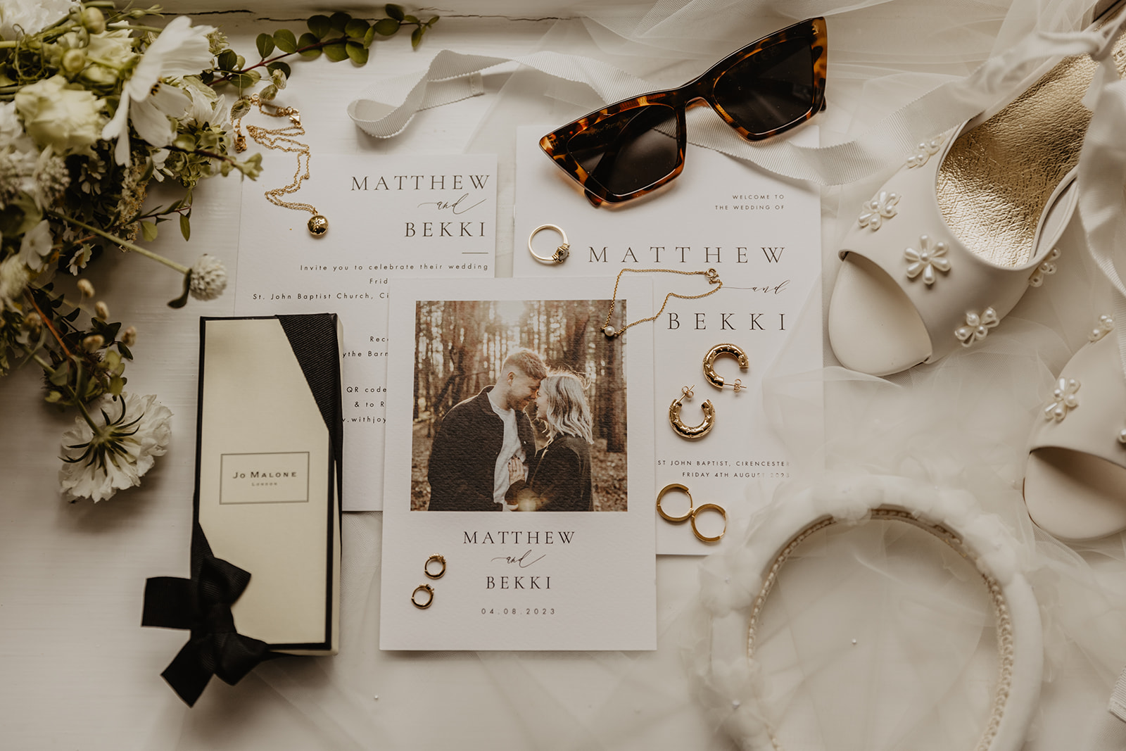 Bride accessory flat lay at a Great Tythe Barn Wedding, Cotswolds. By Olive Joy Photography.